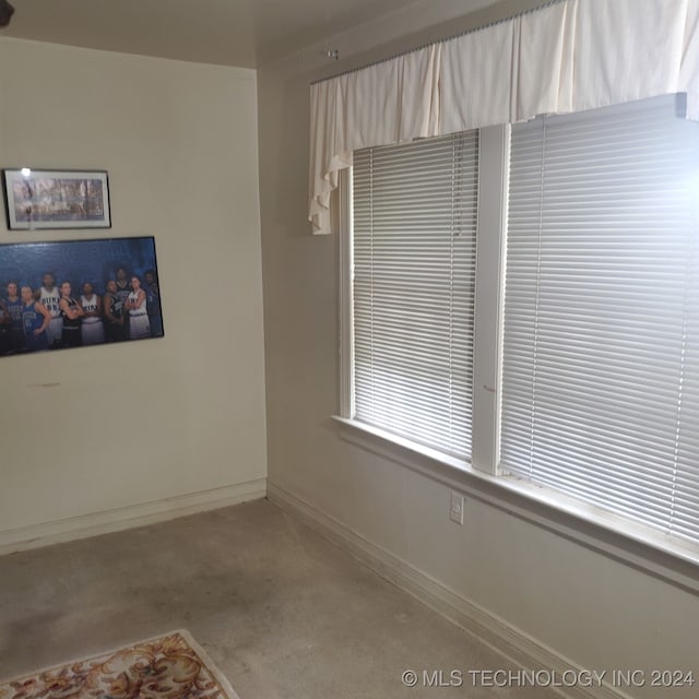 unfurnished room featuring light carpet