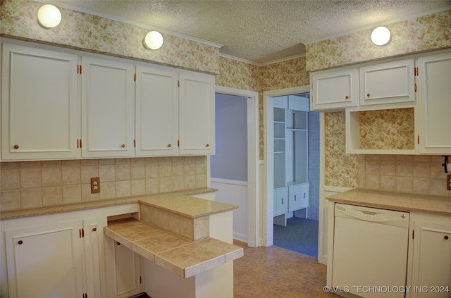 kitchen featuring dishwasher, decorative backsplash, white cabinetry, and a textured ceiling