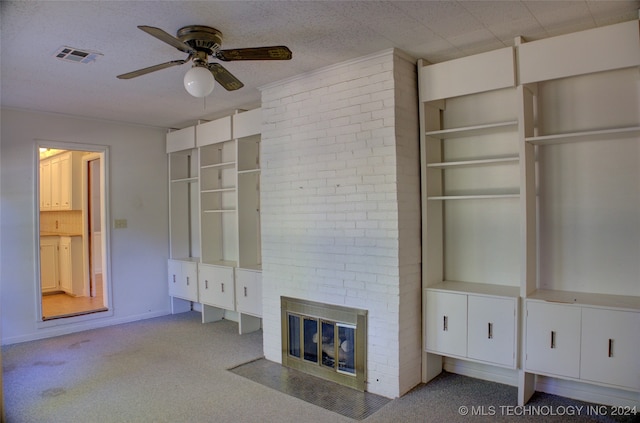 unfurnished living room featuring a brick fireplace, light carpet, and ceiling fan