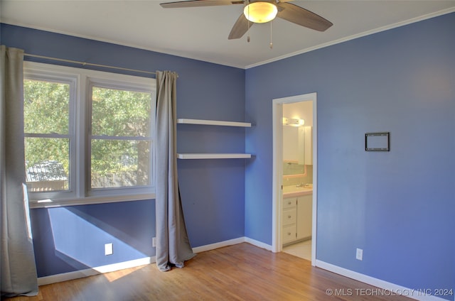 unfurnished bedroom with ensuite bathroom, ceiling fan, ornamental molding, and wood-type flooring