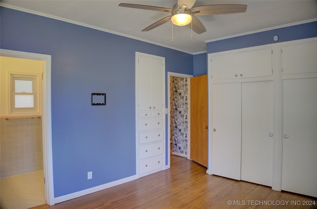 unfurnished bedroom featuring ornamental molding, hardwood / wood-style floors, and ceiling fan