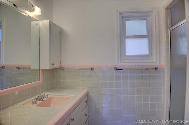 bathroom with tile walls and vanity