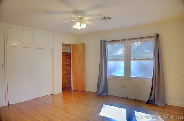 unfurnished bedroom featuring ceiling fan, a closet, and light hardwood / wood-style flooring