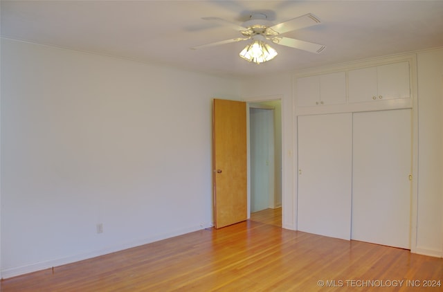 unfurnished bedroom featuring a closet, light wood-type flooring, and ceiling fan