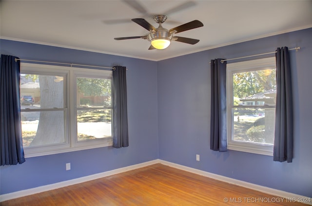 spare room featuring hardwood / wood-style flooring, ceiling fan, and ornamental molding