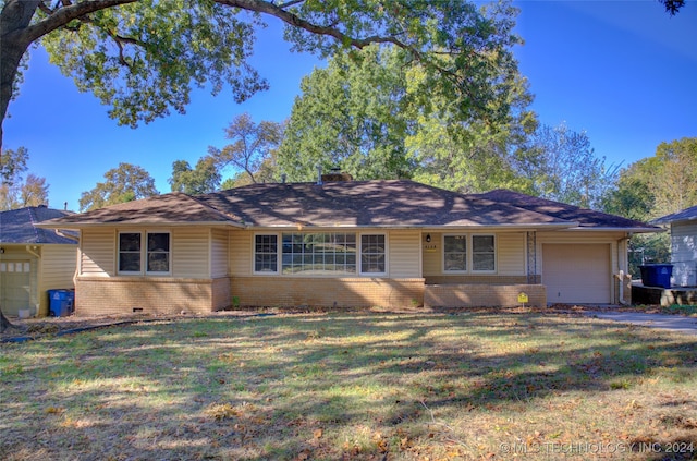 single story home featuring a garage and a front yard