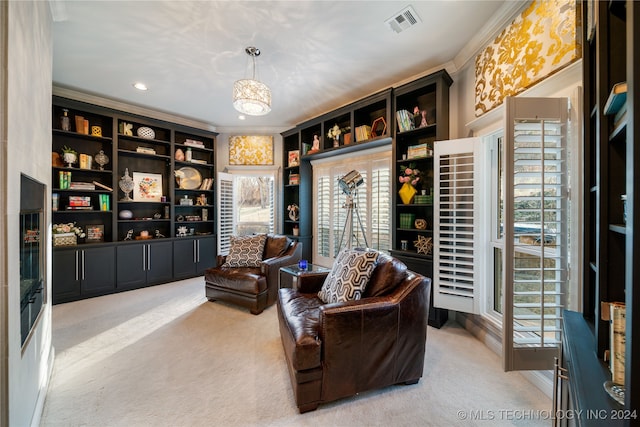 sitting room featuring a healthy amount of sunlight, an inviting chandelier, carpet floors, and ornamental molding