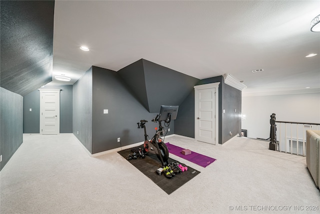 exercise room with carpet flooring and vaulted ceiling