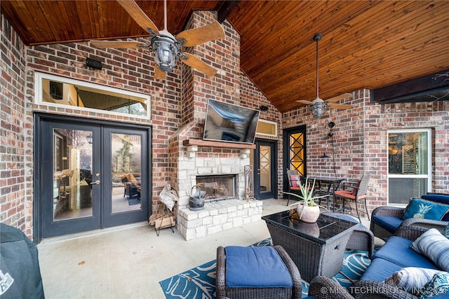 view of patio with french doors, ceiling fan, and an outdoor stone fireplace