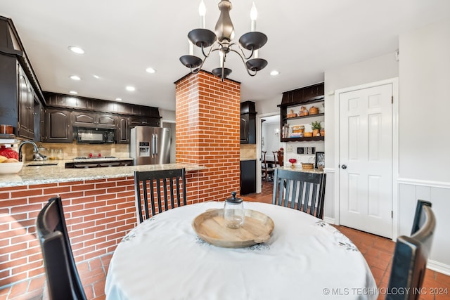 dining space with an inviting chandelier and sink