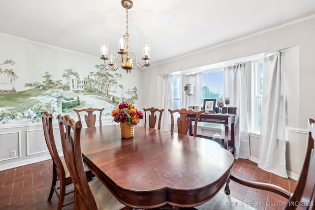 dining space with an inviting chandelier and crown molding