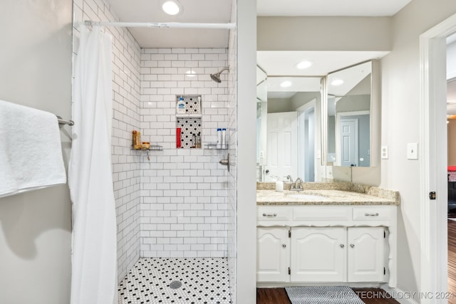 bathroom with a shower with shower curtain, wood-type flooring, and vanity