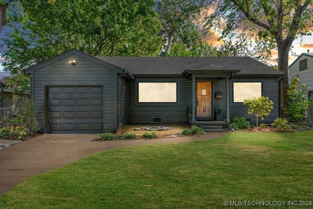 single story home with a lawn and a garage