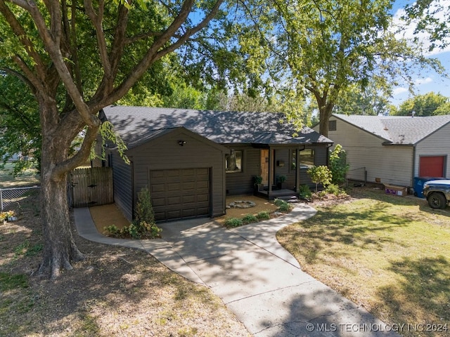 single story home featuring a garage and a front lawn