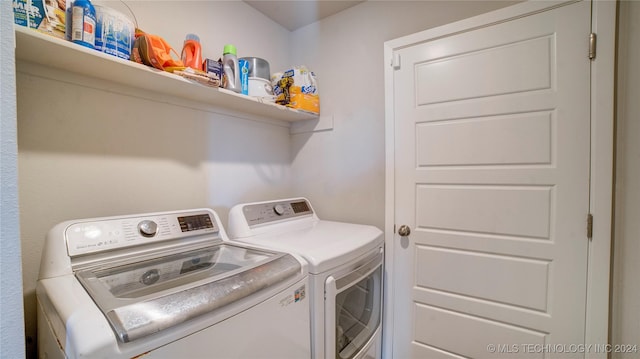 clothes washing area featuring washing machine and clothes dryer