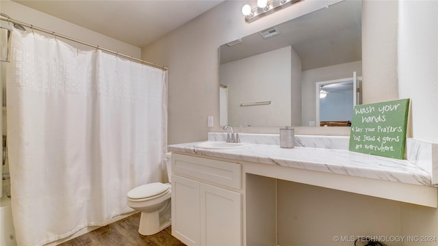 full bathroom featuring toilet, vanity, shower / tub combo, and hardwood / wood-style flooring