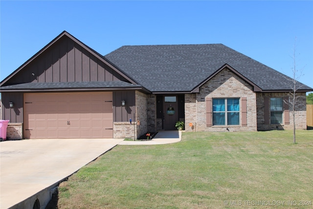 view of front of house with a garage and a front yard