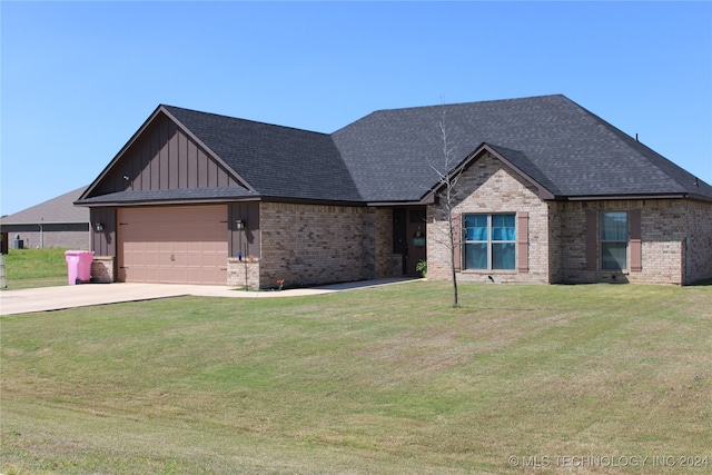 view of front of house featuring a garage and a front lawn