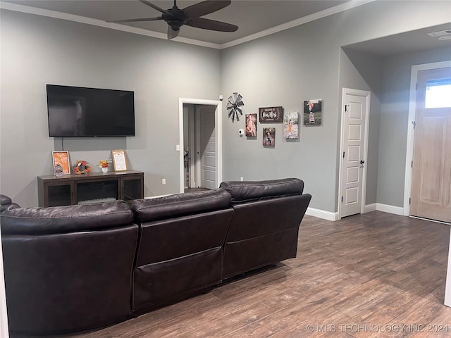 living room with hardwood / wood-style flooring, ceiling fan, and crown molding