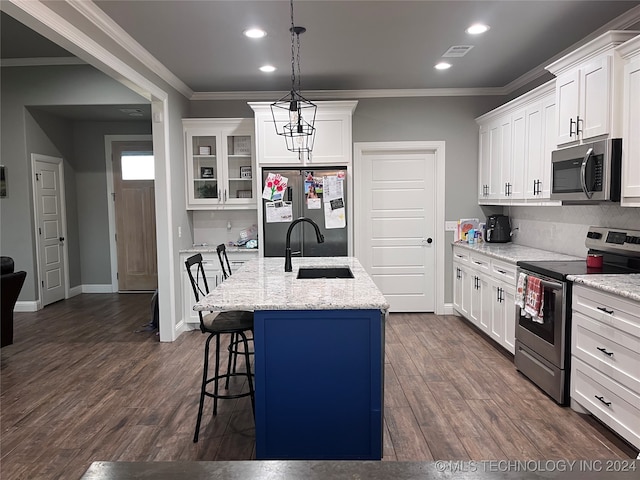 kitchen with white cabinetry, appliances with stainless steel finishes, hanging light fixtures, a kitchen island with sink, and dark hardwood / wood-style flooring