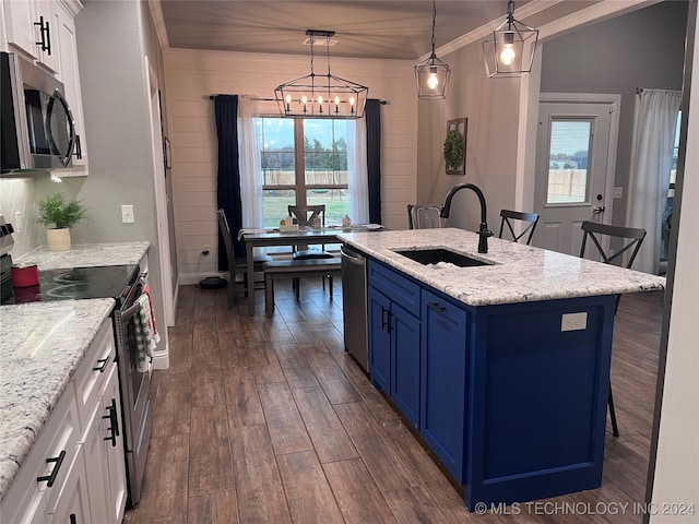 kitchen with stainless steel appliances, blue cabinets, white cabinets, sink, and decorative light fixtures