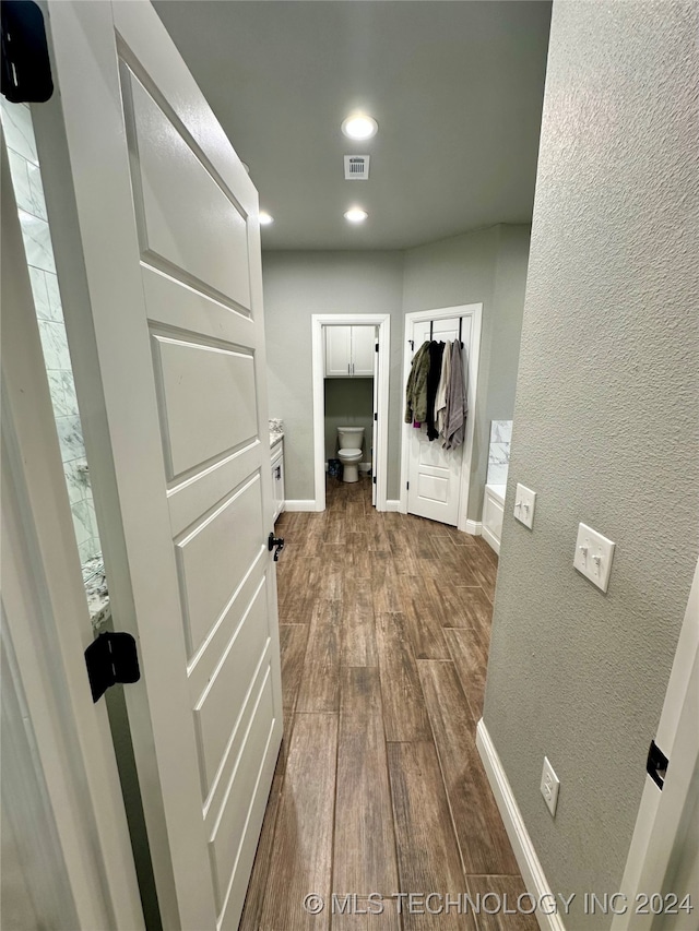 interior space featuring hardwood / wood-style flooring and toilet