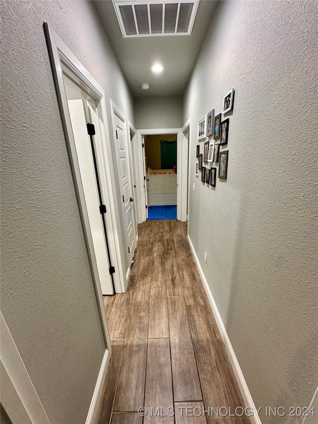 hallway with wood-type flooring