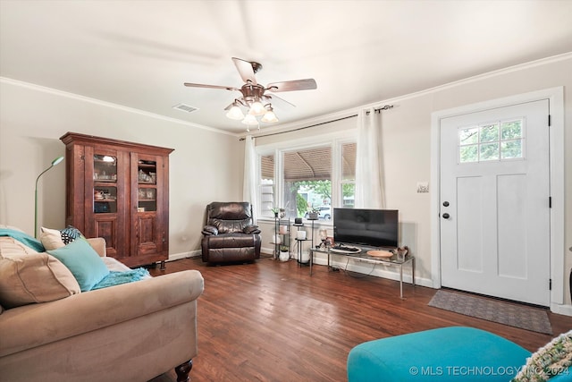 living room with dark wood-type flooring, ceiling fan, and crown molding