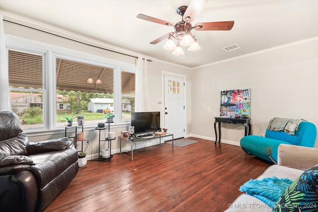 living room with crown molding, a healthy amount of sunlight, and dark hardwood / wood-style floors