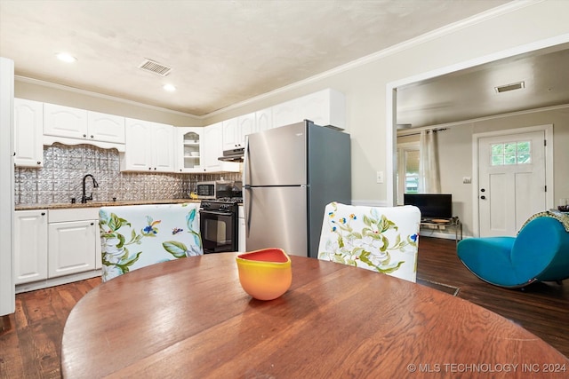 dining space with sink, dark hardwood / wood-style floors, and crown molding