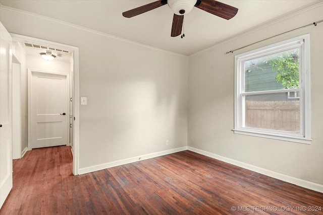 unfurnished room with dark wood-type flooring, ceiling fan, and ornamental molding