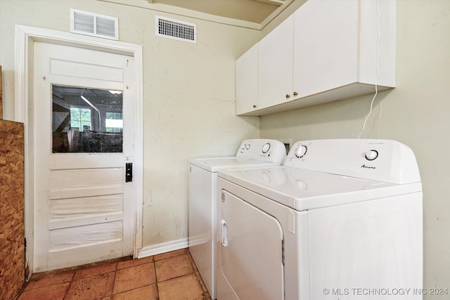 clothes washing area featuring cabinets and independent washer and dryer