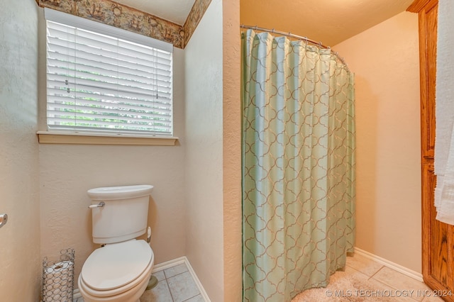 bathroom with toilet, a shower with shower curtain, and tile patterned flooring