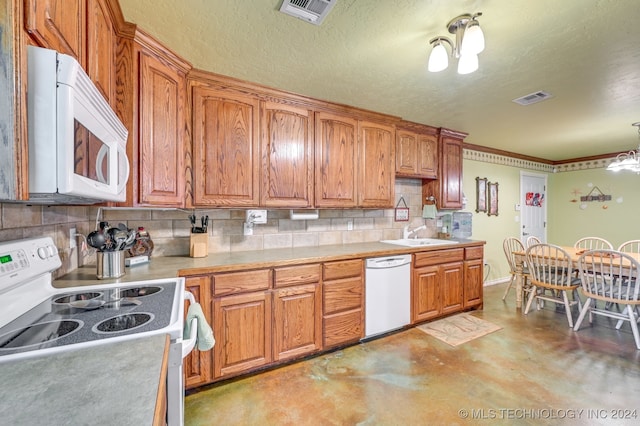 kitchen with sink, a textured ceiling, backsplash, white appliances, and a chandelier