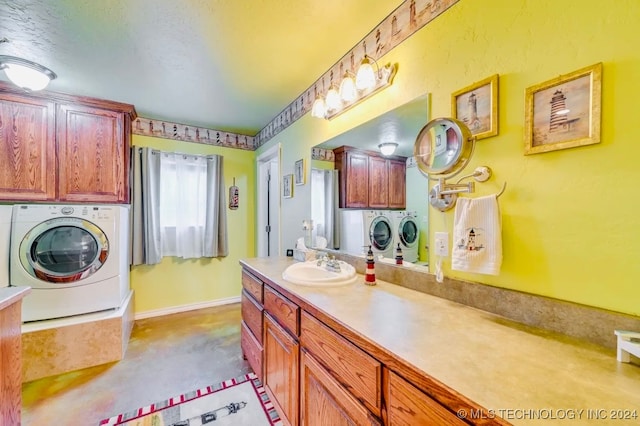 bathroom featuring vanity, washer and dryer, and concrete floors