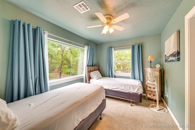 bedroom featuring ceiling fan and light colored carpet