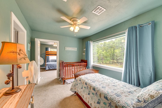 bedroom featuring ceiling fan and carpet