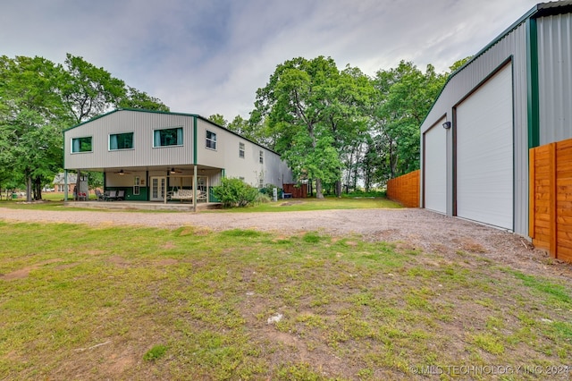 view of yard featuring an outbuilding and a garage