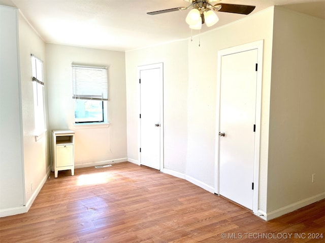 unfurnished bedroom featuring light hardwood / wood-style floors, ceiling fan, and ornamental molding