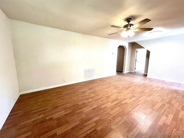 empty room with hardwood / wood-style flooring and ceiling fan