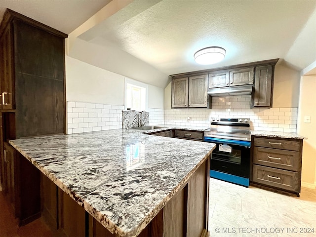 kitchen with light stone countertops, decorative backsplash, stainless steel range with electric cooktop, and kitchen peninsula