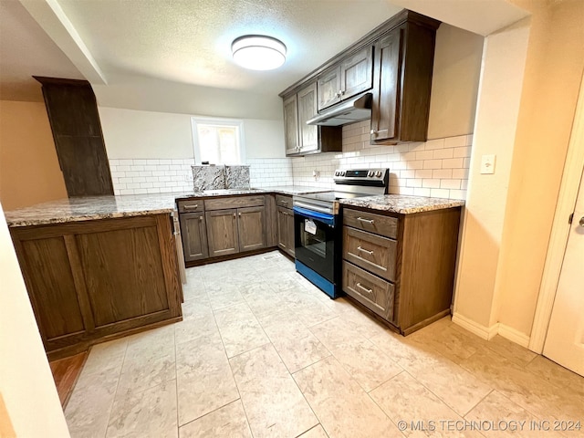 kitchen with electric stove, a textured ceiling, sink, tasteful backsplash, and light stone countertops