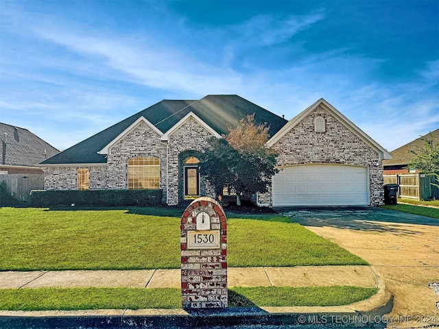 view of front facade with a front lawn and a garage