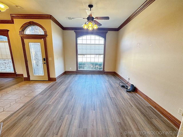 foyer entrance with ceiling fan, light wood-type flooring, and ornamental molding