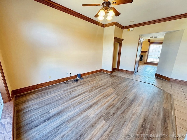 spare room with light hardwood / wood-style floors, ceiling fan, and ornamental molding