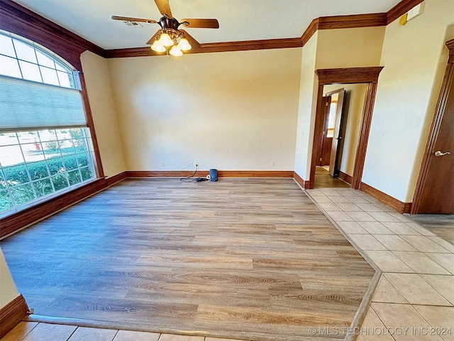 spare room with ceiling fan, plenty of natural light, light wood-type flooring, and ornamental molding