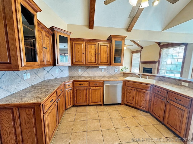 kitchen with vaulted ceiling with beams, sink, tasteful backsplash, light tile patterned floors, and stainless steel dishwasher