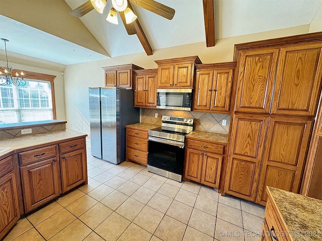 kitchen with vaulted ceiling with beams, appliances with stainless steel finishes, light tile patterned floors, pendant lighting, and ceiling fan with notable chandelier