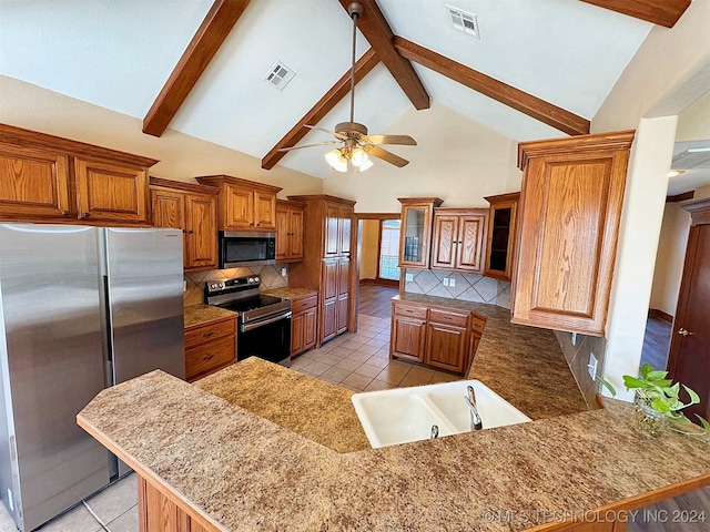 kitchen featuring sink, kitchen peninsula, appliances with stainless steel finishes, beam ceiling, and high vaulted ceiling