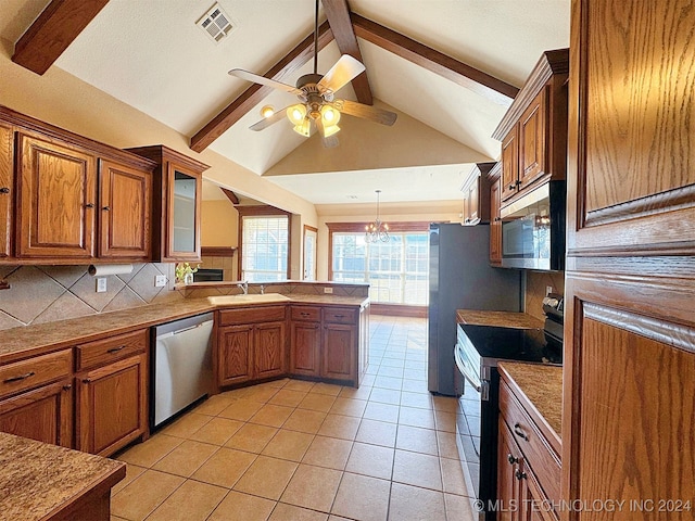 kitchen with lofted ceiling with beams, appliances with stainless steel finishes, sink, and decorative backsplash